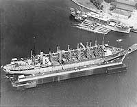 Photo # 80-CF-22672-1: USS Canopus in the background of a photo of USS Jason in the Dewey Drydock at Olongapo, Philippines, 9 March 1932