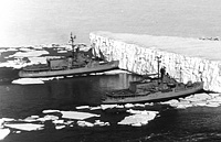 USS Atka (AGB 3) with USS Burton Island (AGB 1) and an iceberg on 29 December 1965