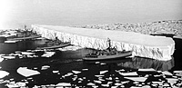 USS Glacier (AGB 4), USS Atka (AGB 3), and USS Burton Island (AGB 1) pushing an iceberg on 29 December 1965