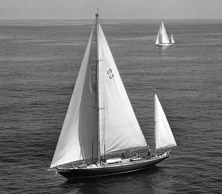 USS Royono (IX 235) in a Bermuda race with yacht Enchanta in the background.